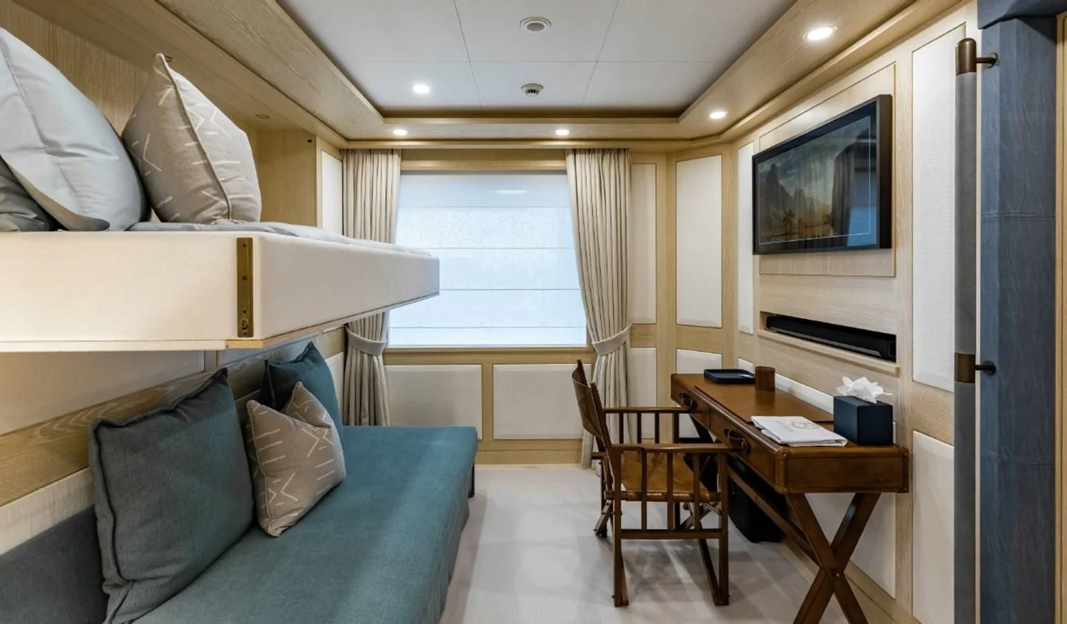 a living room with a couch and a television aboard Q Yacht for Sale