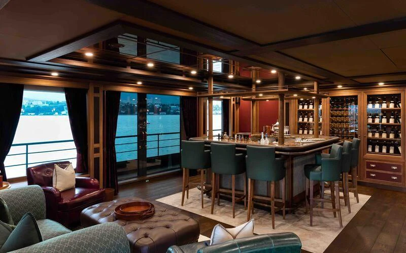 a room with a table chairs and a large window aboard Q Yacht for Sale