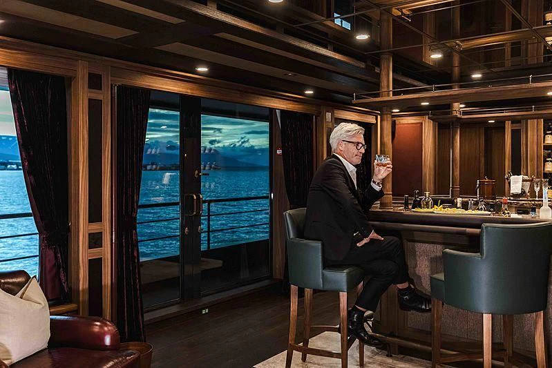 a person sitting at a table aboard Q Yacht for Sale