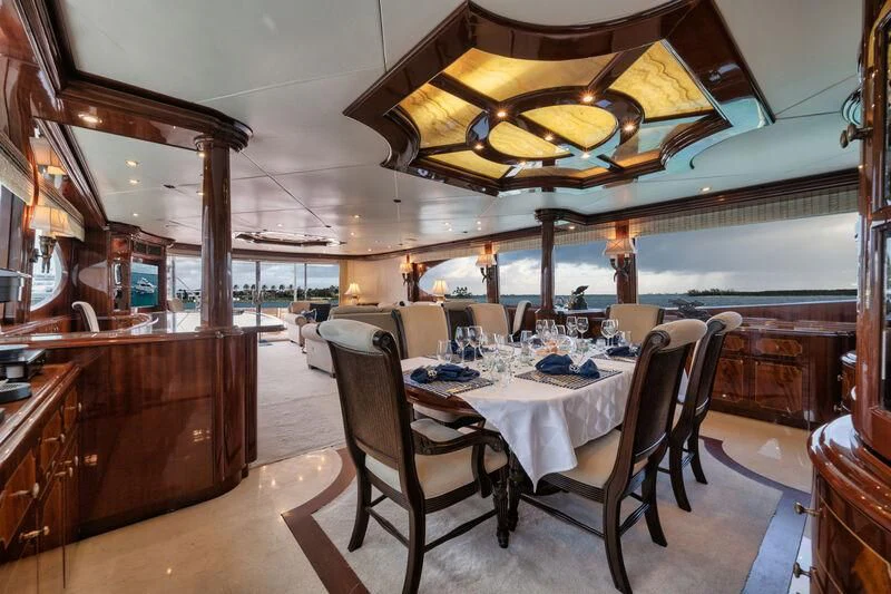 a dining room with a table and chairs aboard LADY KRISTINA Yacht for Sale