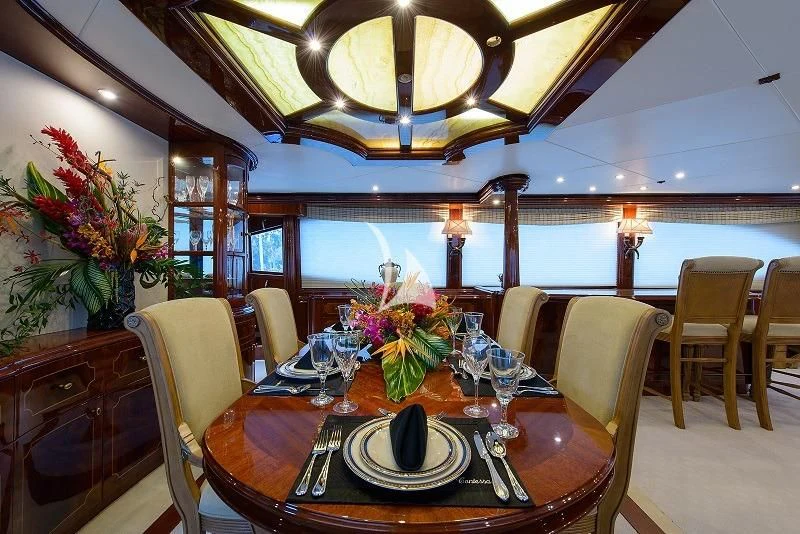 a dining room with a table set for a dinner aboard LADY KRISTINA Yacht for Sale