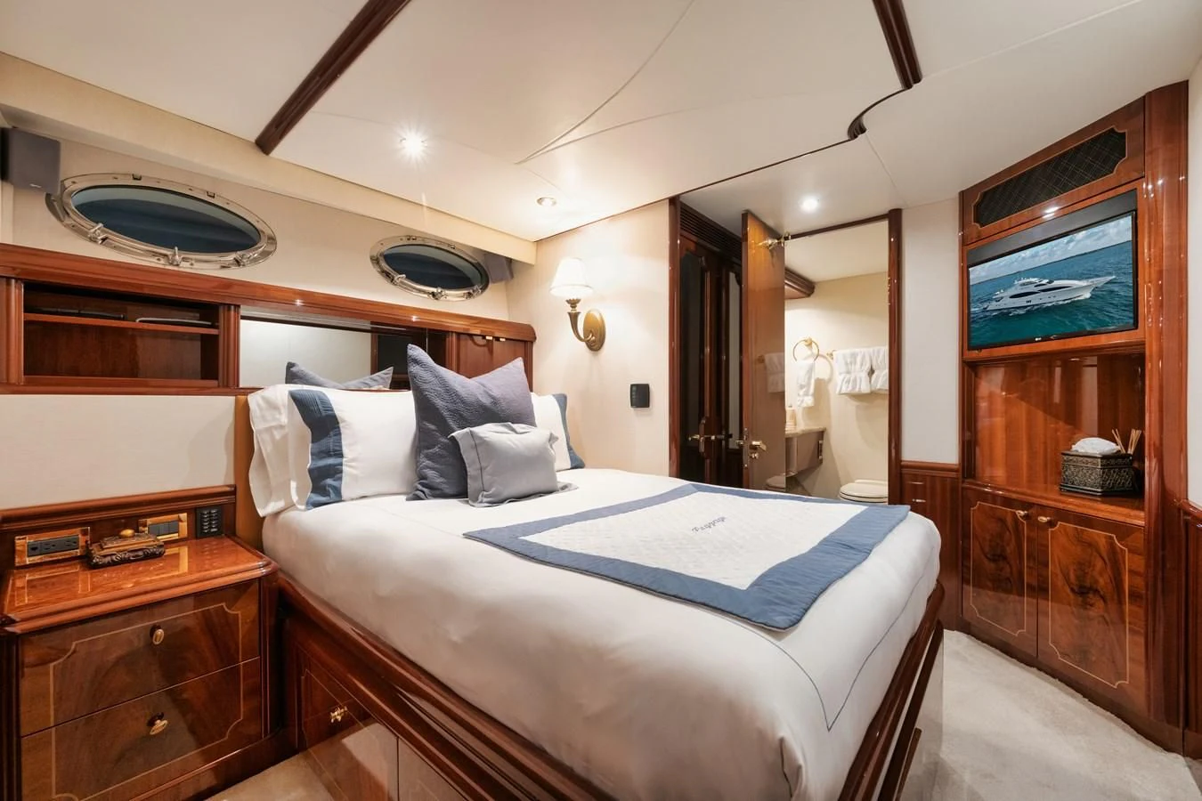 a bedroom with a bed and a mirror aboard LADY KRISTINA Yacht for Sale