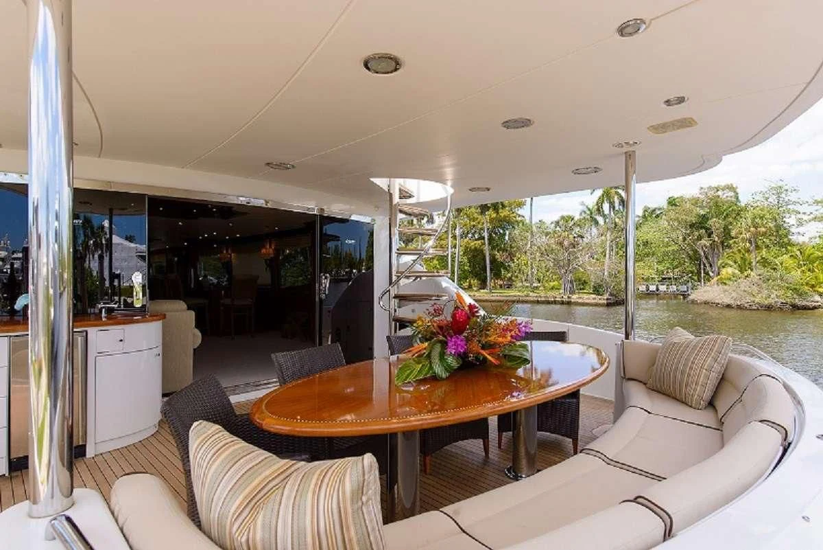 a living room with a table and chairs aboard LADY KRISTINA Yacht for Sale
