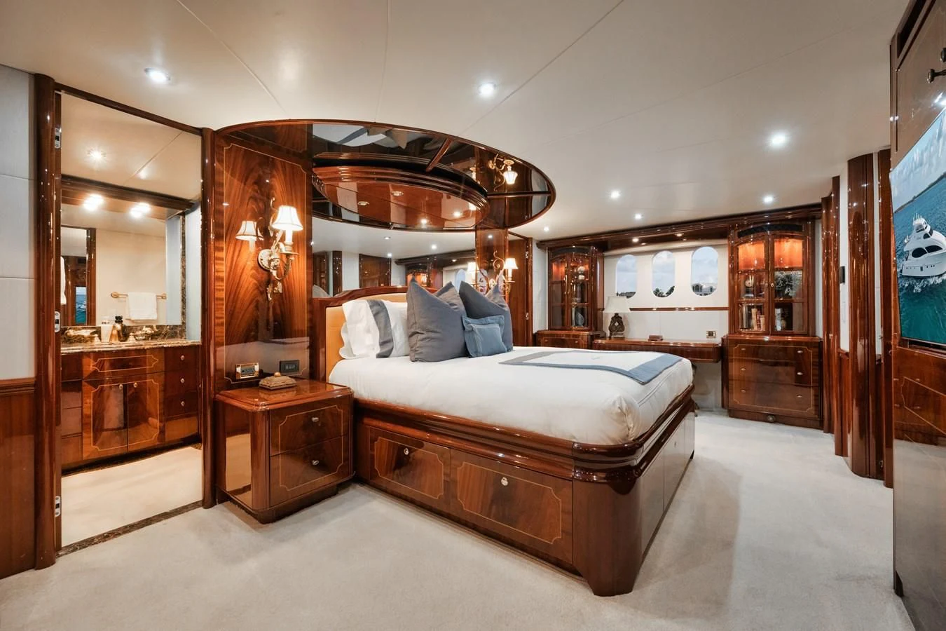 a bedroom with a bed and a dresser aboard LADY KRISTINA Yacht for Sale