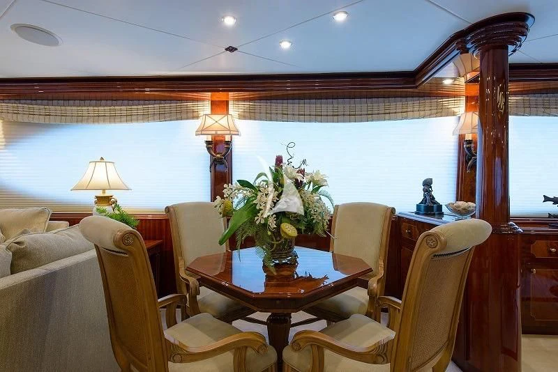 a living room with a table and chairs aboard LADY KRISTINA Yacht for Sale