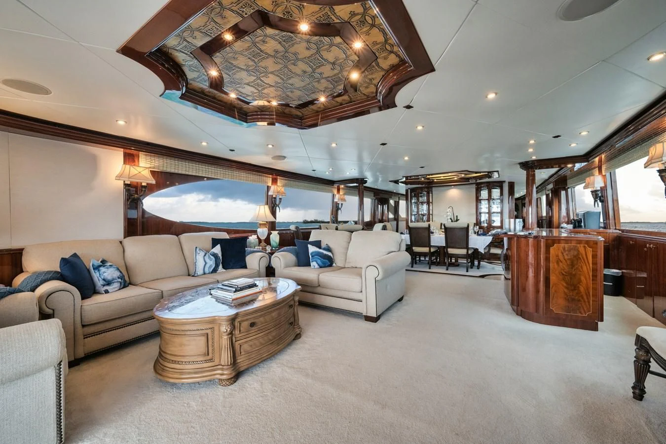 a large living room with a large chandelier aboard LADY KRISTINA Yacht for Sale
