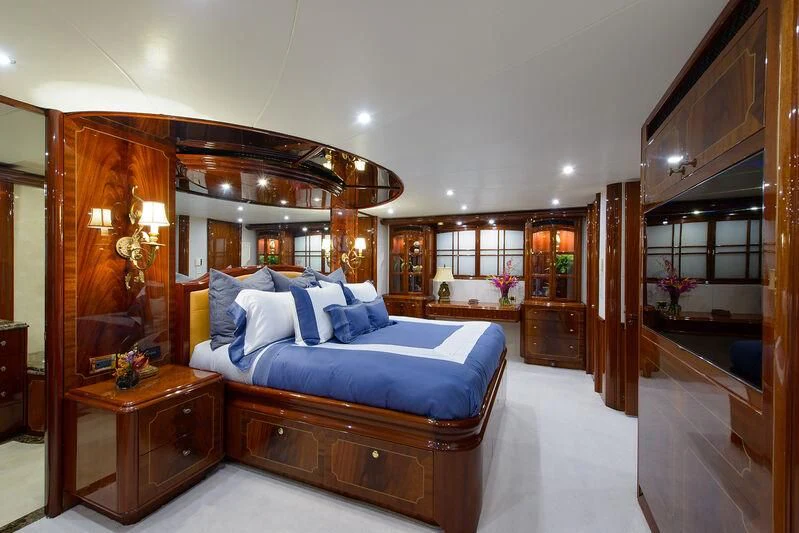 a bedroom with a bed and a mirror aboard LADY KRISTINA Yacht for Sale