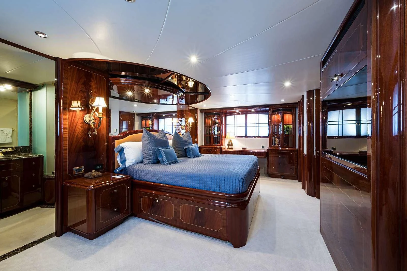 a bedroom with a bed and a mirror aboard LADY KRISTINA Yacht for Sale