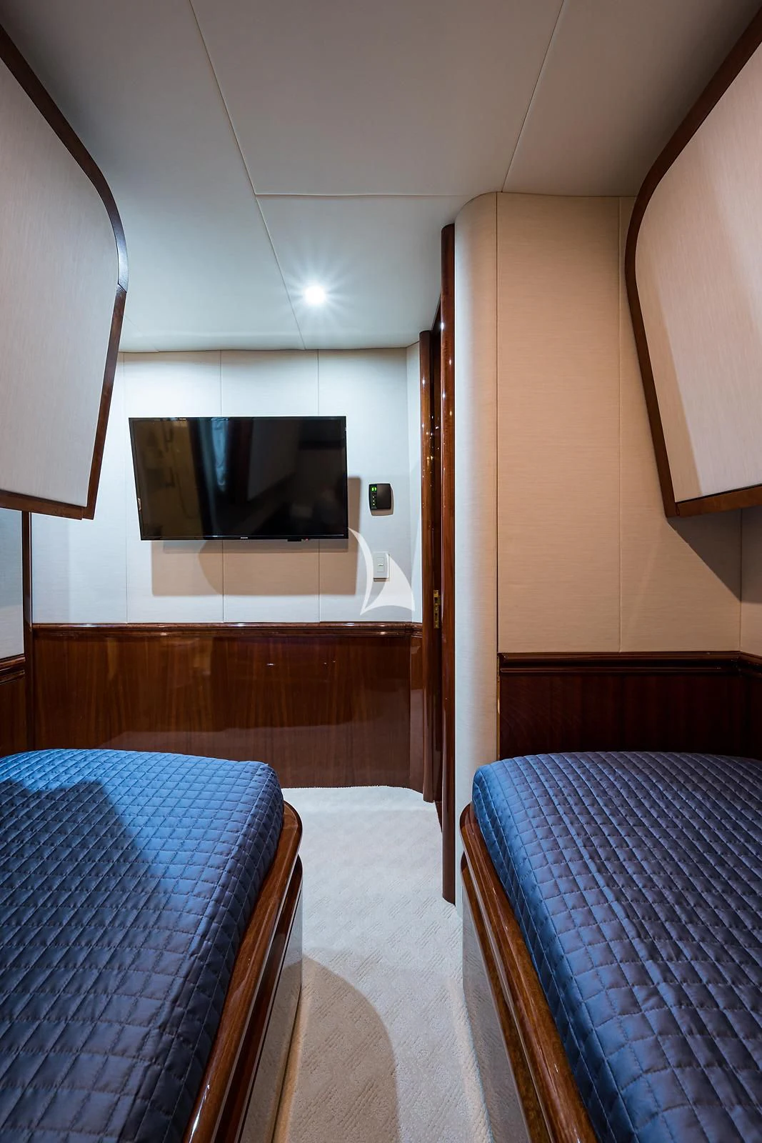 a bedroom with a television on the wall aboard LADY KRISTINA Yacht for Sale