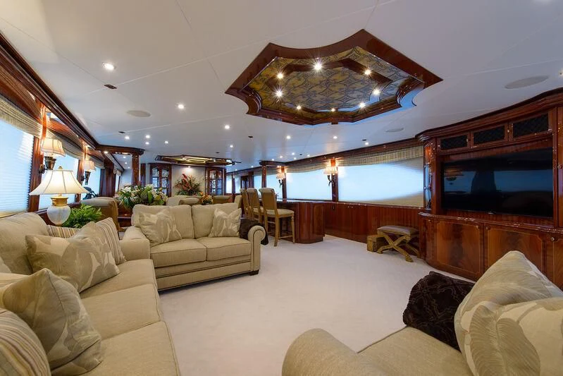 a living room with a large chandelier aboard LADY KRISTINA Yacht for Sale