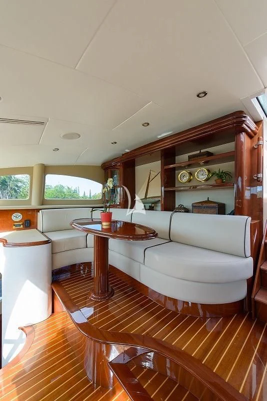 a living room with a table and couch aboard LADY KRISTINA Yacht for Sale