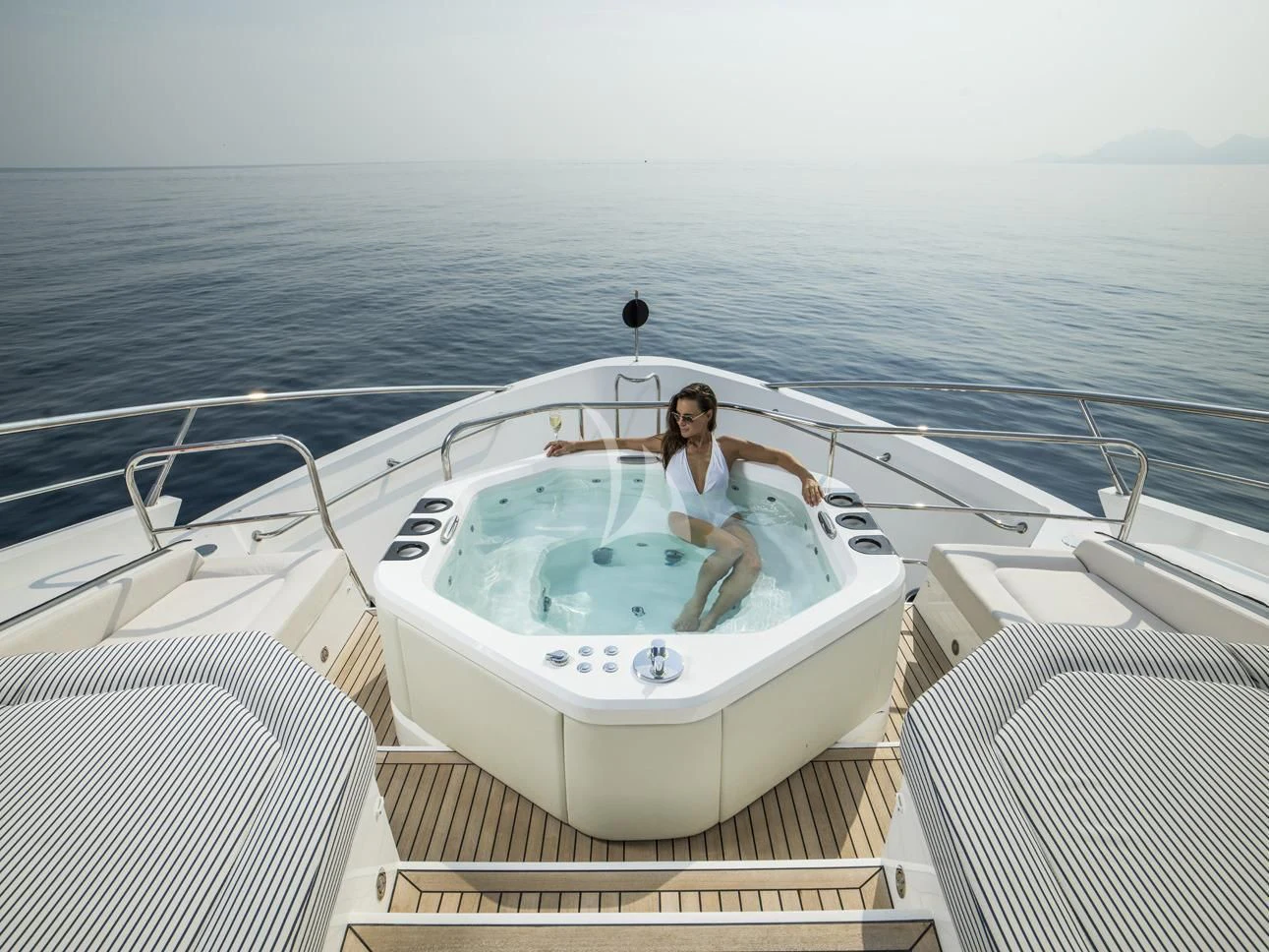 a person sitting on a boat aboard FLEUR Yacht for Charter