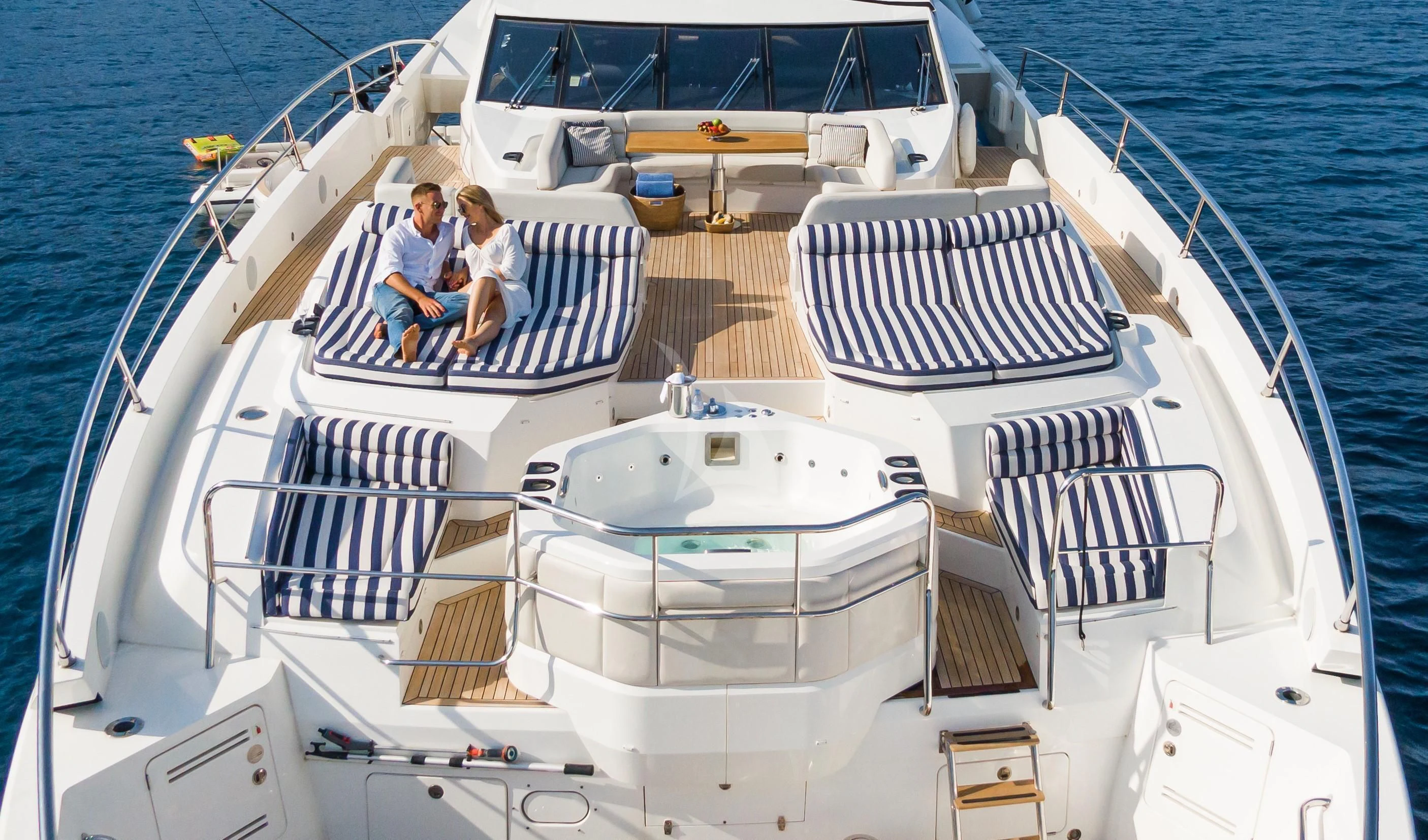 a couple sitting on a boat aboard FLEUR Yacht for Charter