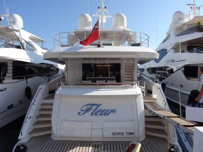 a boat with a flag on the front aboard FLEUR Yacht for Charter