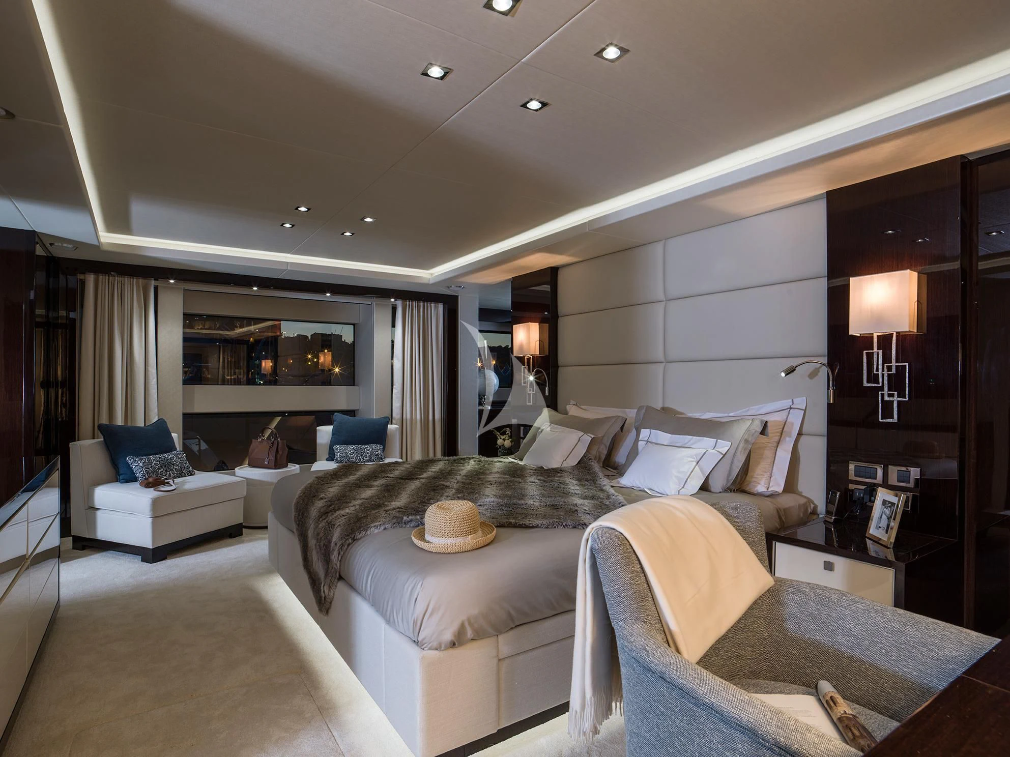 a bedroom with a bed and a chair aboard FLEUR Yacht for Charter