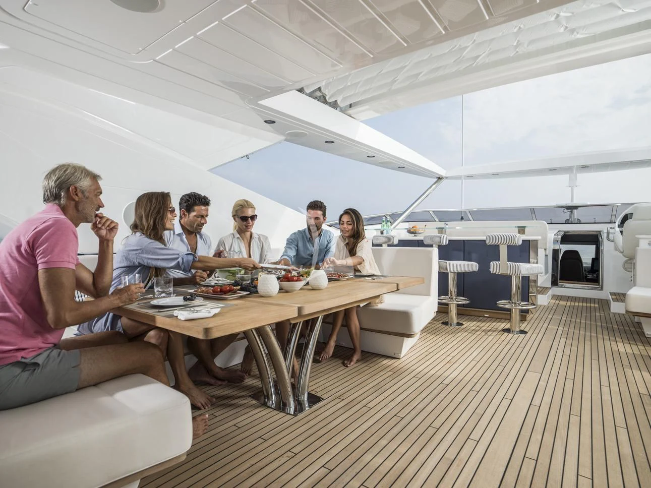 a group of people eating at a table aboard FLEUR Yacht for Charter