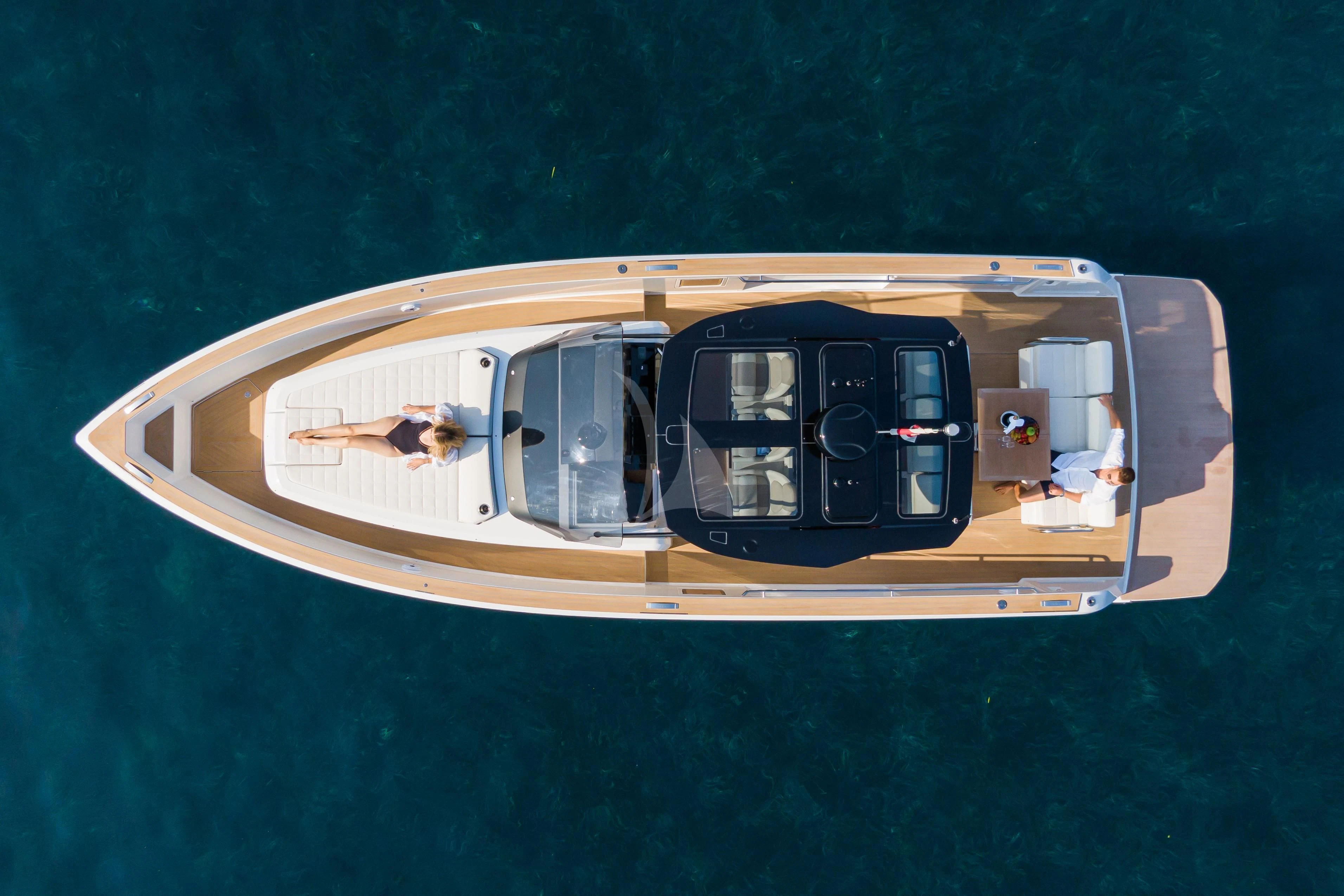 a yellow and black boat with a window and a white door on a blue surface aboard FLEUR Yacht for Charter