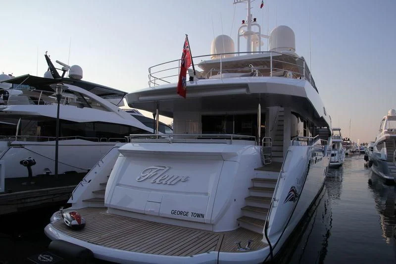 a large white boat sits in the water aboard FLEUR Yacht for Charter