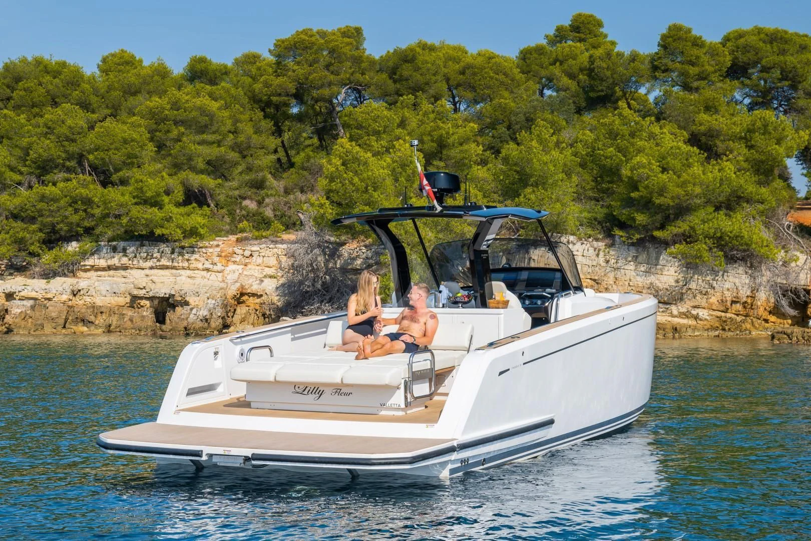 a couple of people in a small boat aboard FLEUR Yacht for Charter
