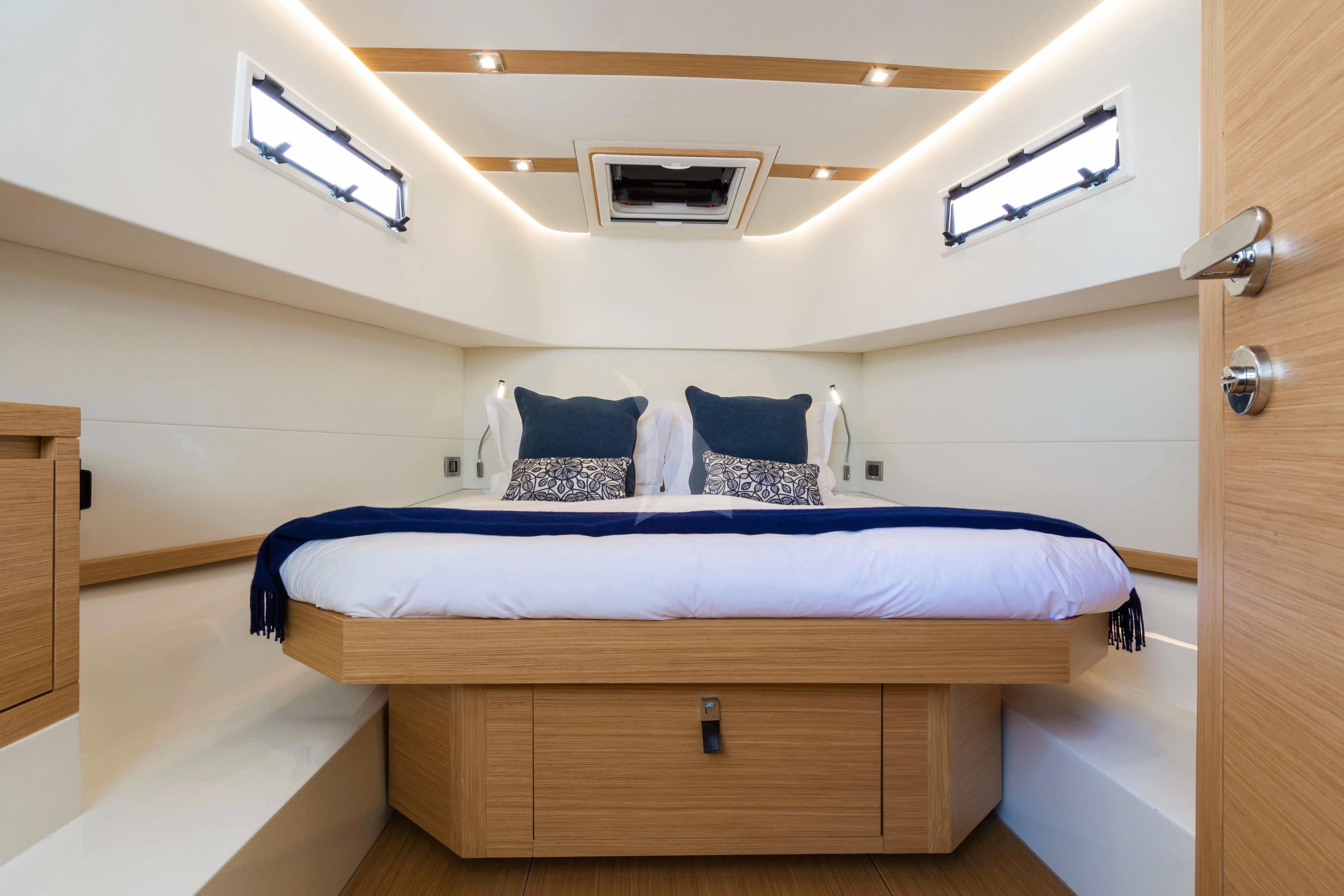 a bedroom with a bed and a desk aboard FLEUR Yacht for Charter