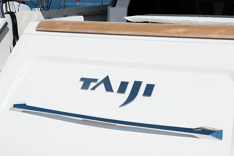 a white sign with black text on it aboard TAIJI Yacht for Sale