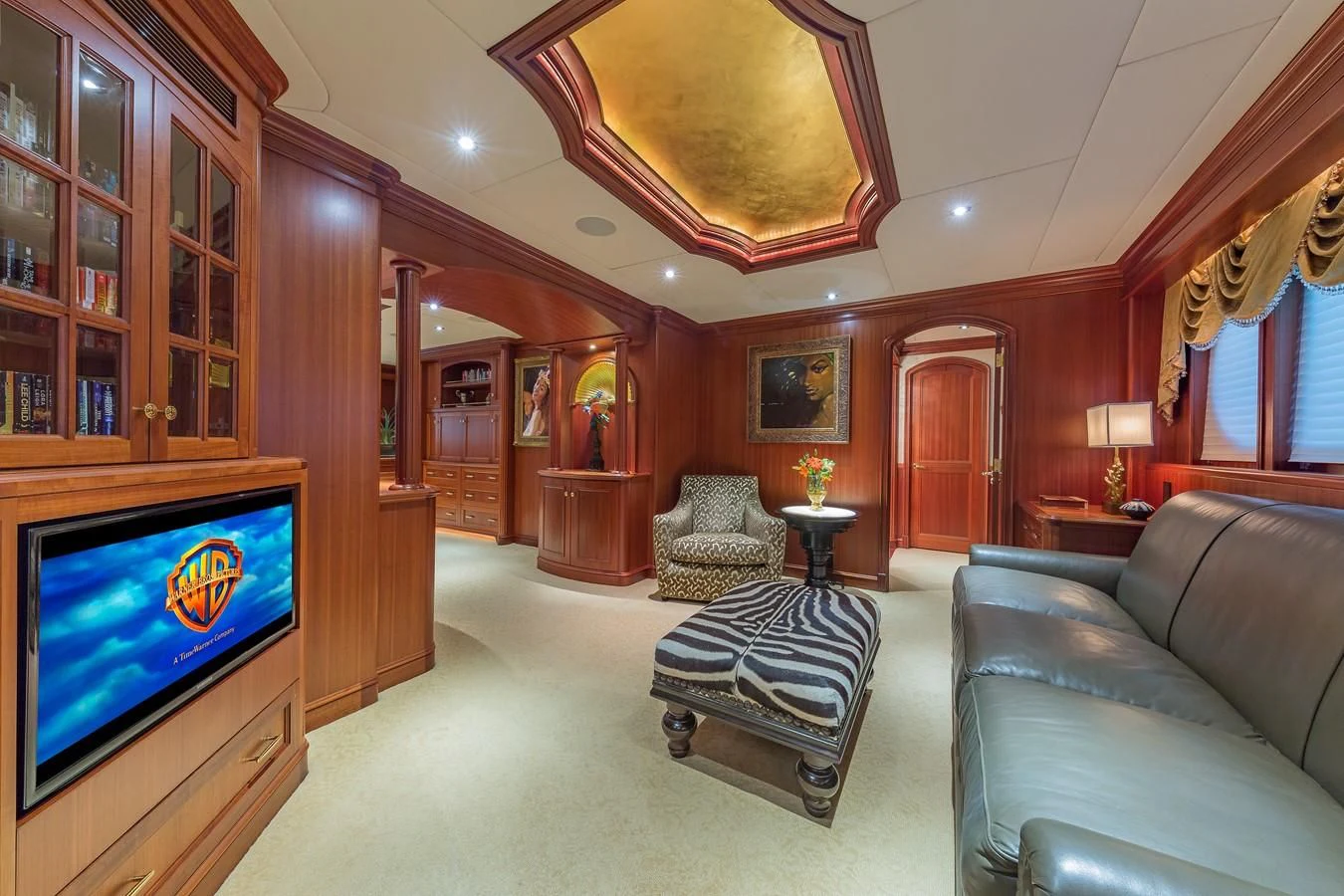 a living room with a couch and a television aboard SORCHA Yacht for Sale