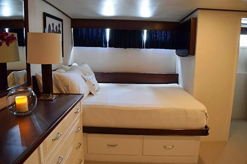 a room with a bed and a lamp aboard AURORE Yacht for Sale