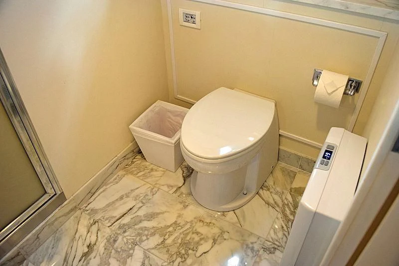 a bathroom with a toilet and a roll of toilet paper aboard AURORE Yacht for Sale