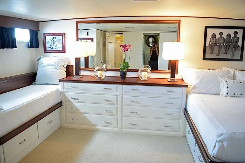 a room with a bed and a mirror aboard AURORE Yacht for Sale
