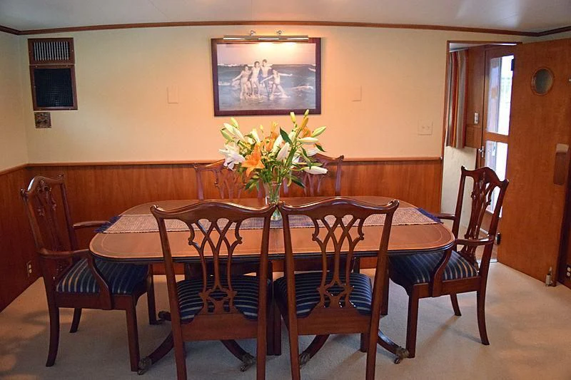 a dining table with chairs around it aboard AURORE Yacht for Sale