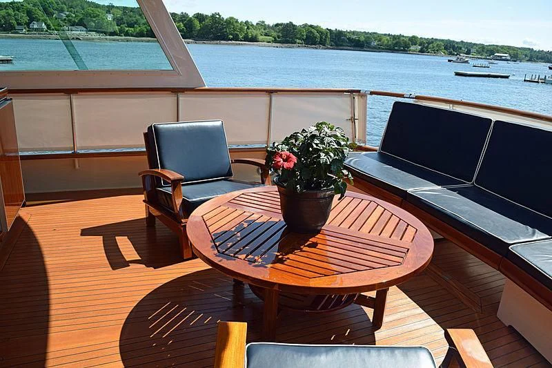 a table and chairs on a deck aboard AURORE Yacht for Sale