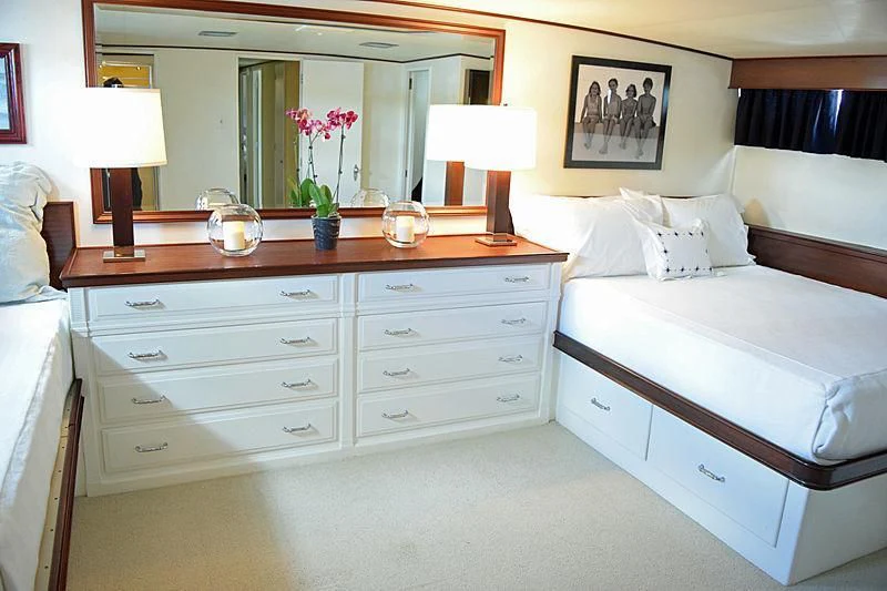 a bedroom with a bed and a dresser aboard AURORE Yacht for Sale