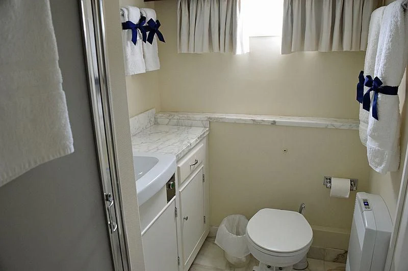 a bathroom with a toilet and sink aboard AURORE Yacht for Sale