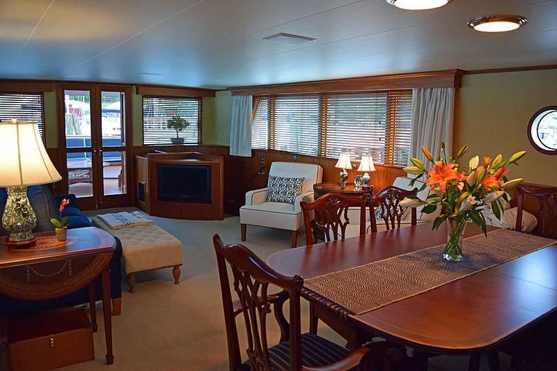a living room with a table and chairs aboard AURORE Yacht for Sale