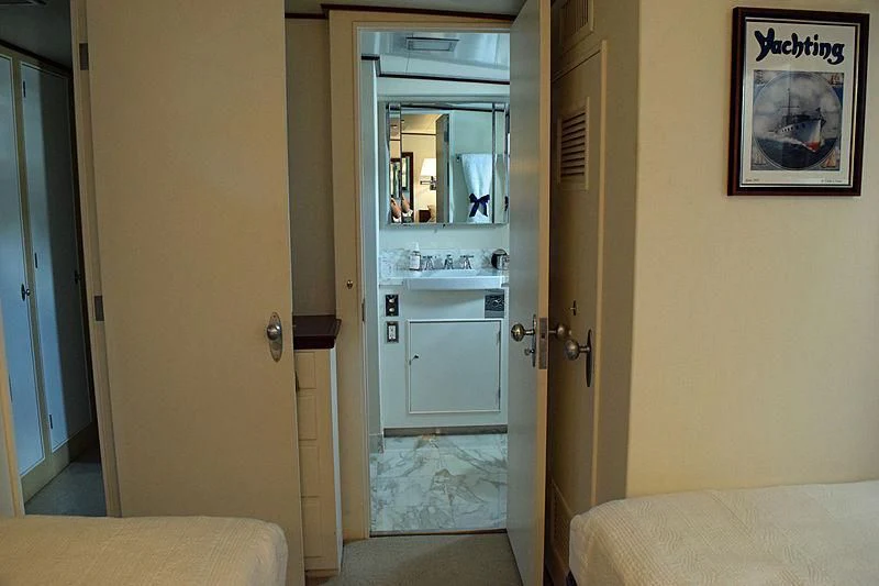 a room with a bed and a door aboard AURORE Yacht for Sale