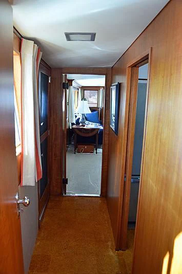 a hallway with a door and a mirror aboard AURORE Yacht for Sale
