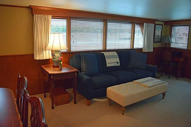 a living room with a couch and a coffee table aboard AURORE Yacht for Sale