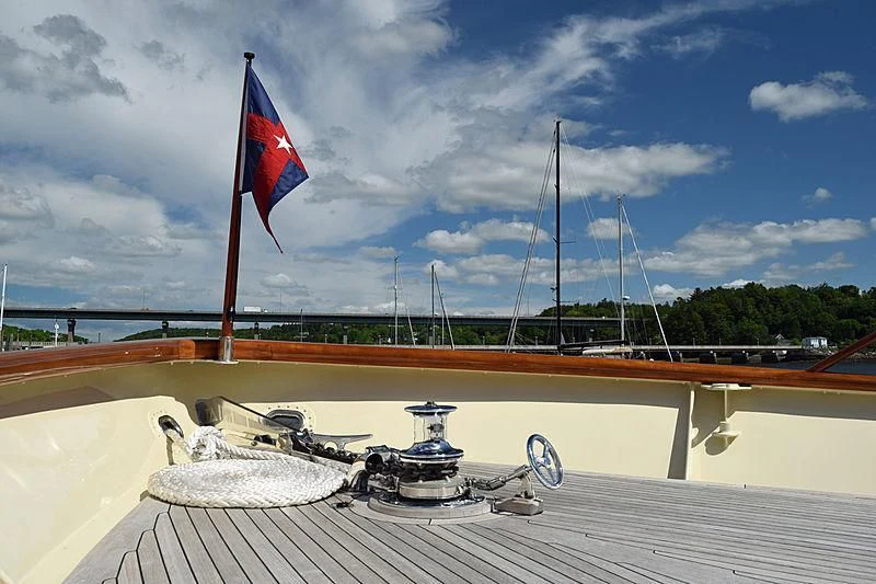 a boat with a flag on it aboard AURORE Yacht for Sale