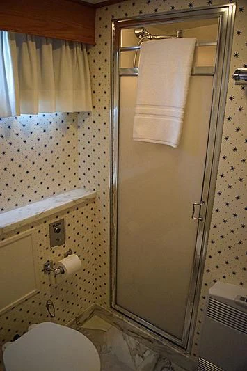 a bathroom with a toilet and a shower aboard AURORE Yacht for Sale