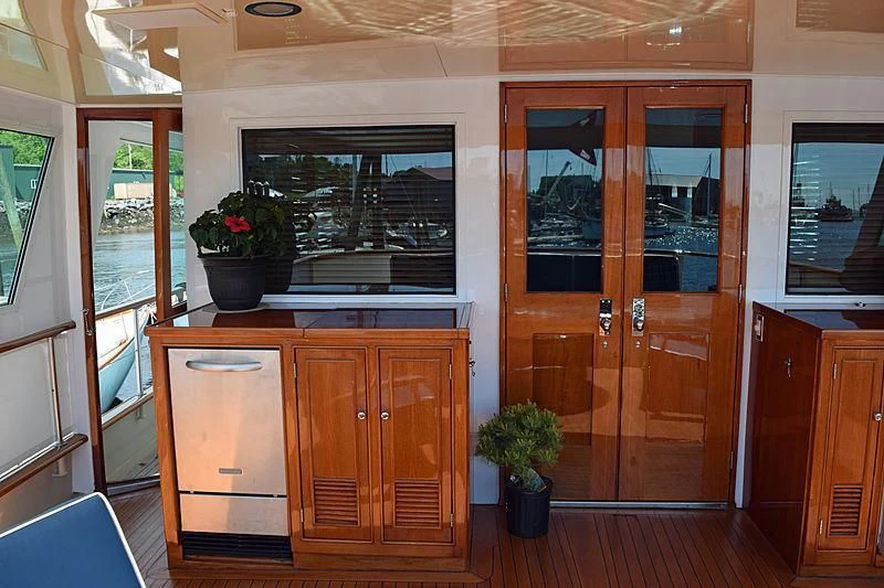 a kitchen with wooden cabinets aboard AURORE Yacht for Sale