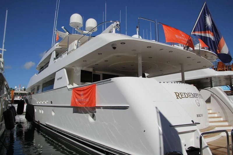 a large white boat with flags on it aboard ELYSIAN Yacht for Sale