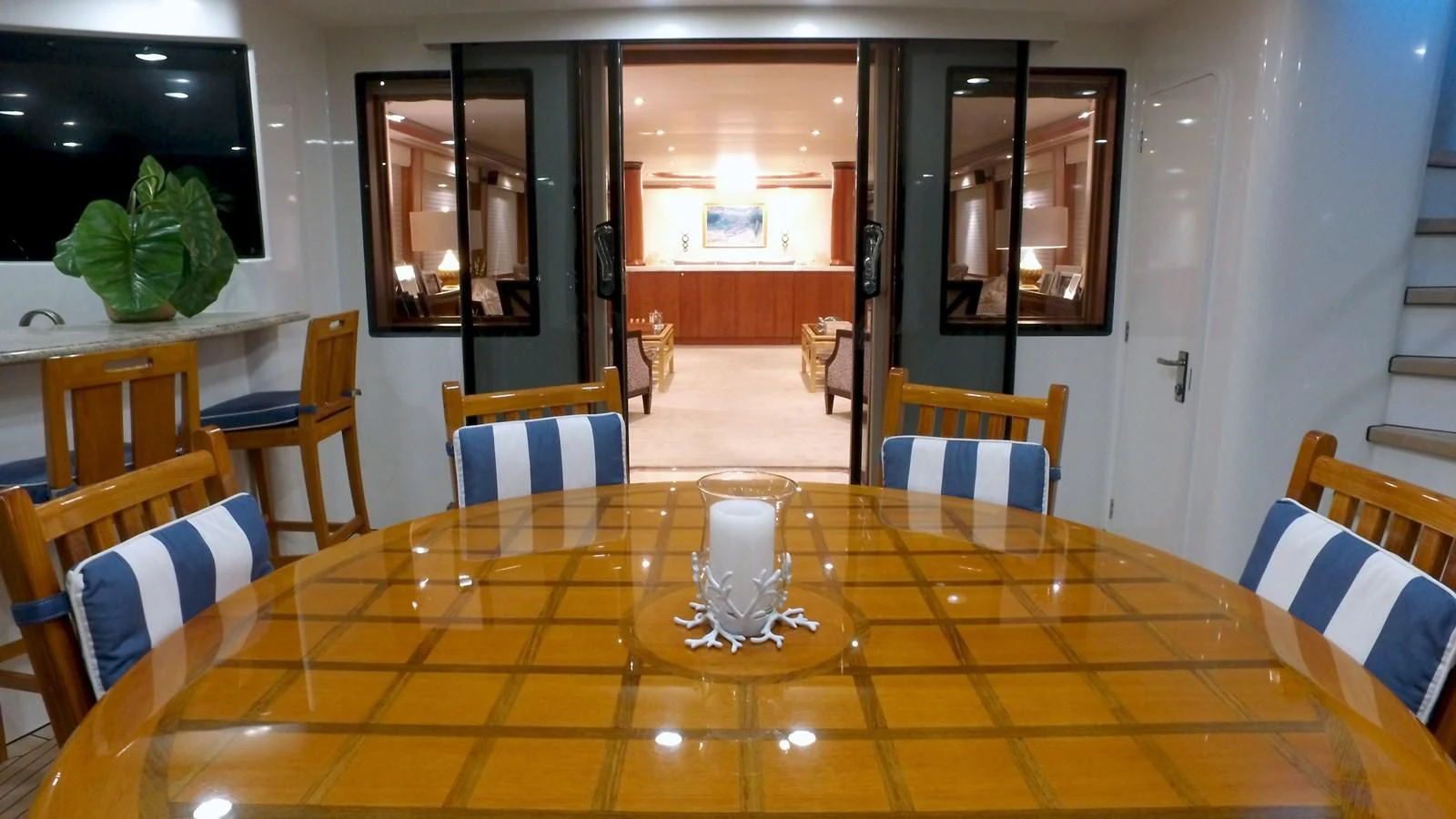 a table with chairs and a vase on it aboard ELYSIAN Yacht for Sale