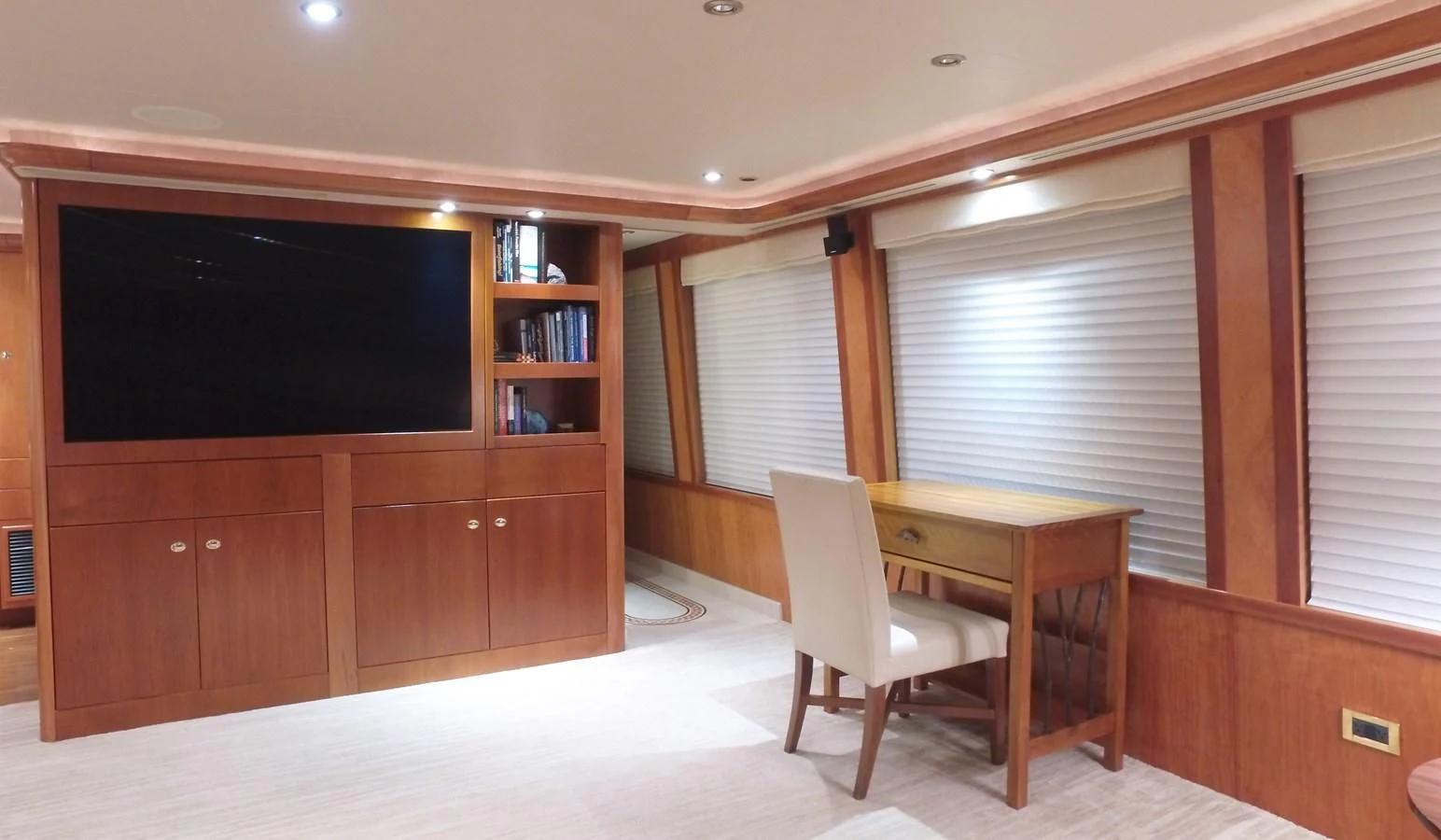 a room with a tv and a table aboard ELYSIAN Yacht for Sale