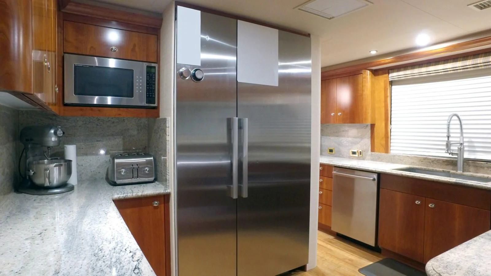 a kitchen with a stainless steel refrigerator aboard ELYSIAN Yacht for Sale