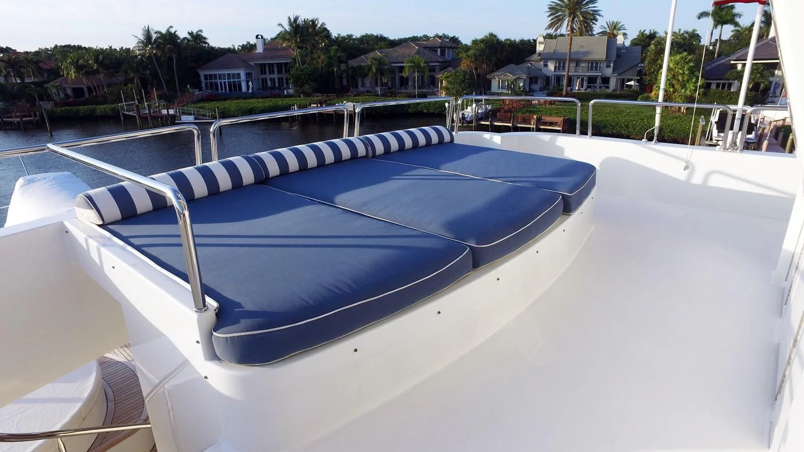a pool with a deck and trees in the background aboard ELYSIAN Yacht for Sale