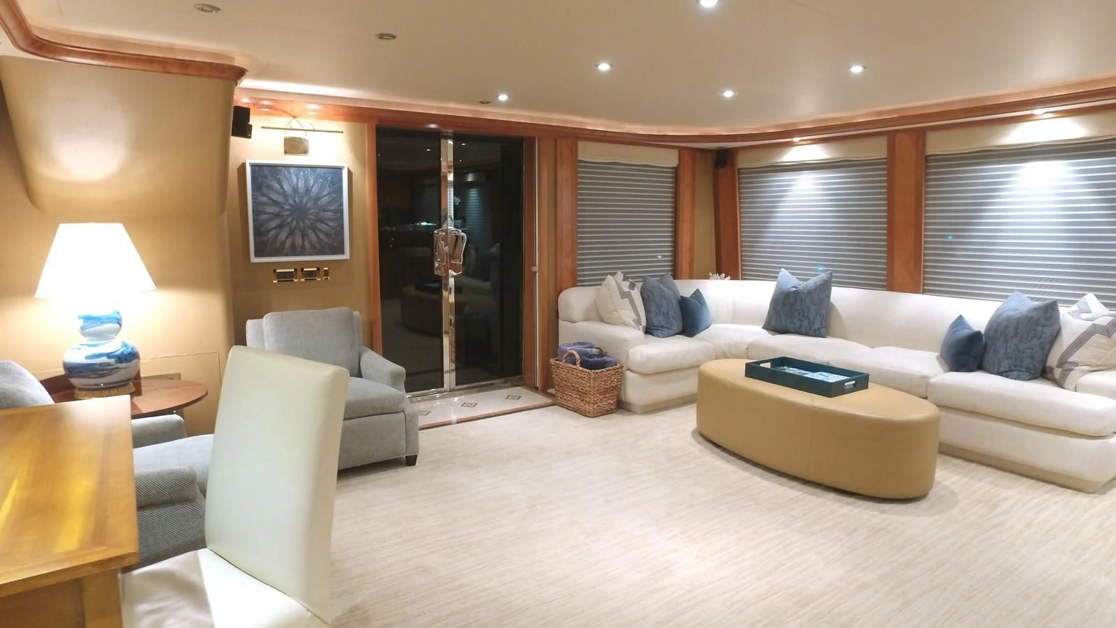 a large living room with a white couch and a large mirror aboard ELYSIAN Yacht for Sale