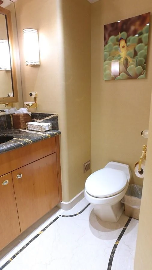 a bathroom with a toilet and a sink aboard ELYSIAN Yacht for Sale