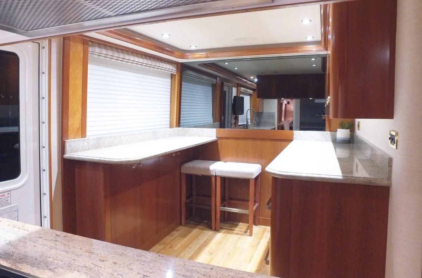 a kitchen with a table and stools aboard ELYSIAN Yacht for Sale