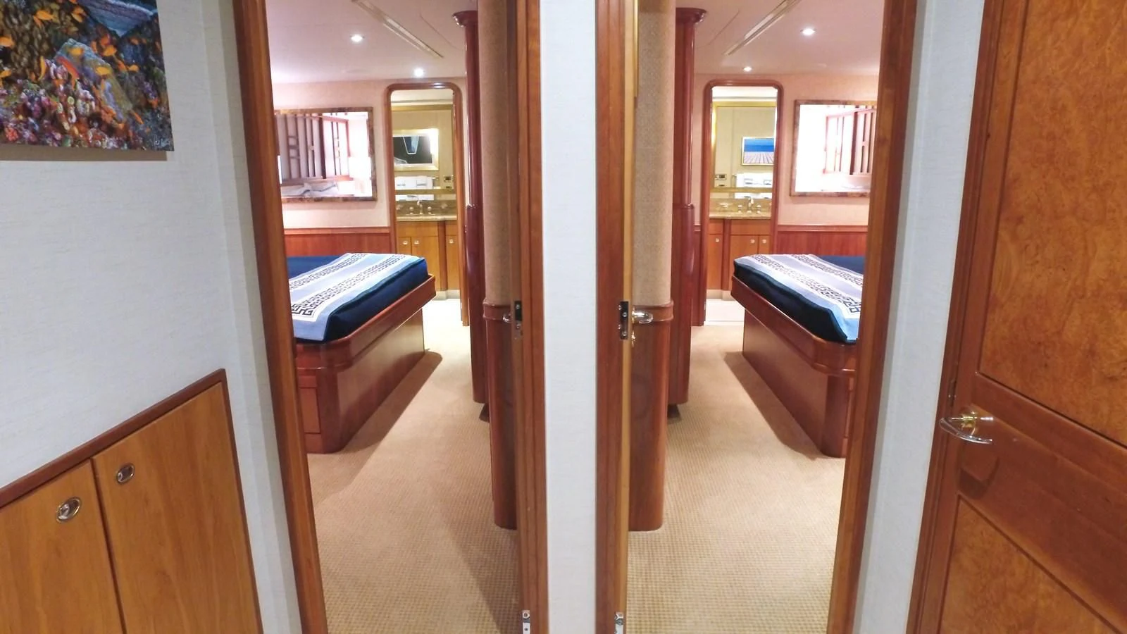 a hallway with a bed and a desk aboard ELYSIAN Yacht for Sale
