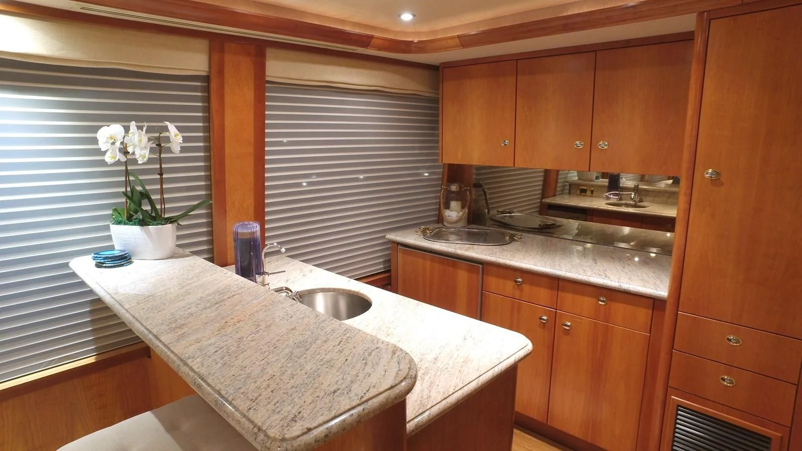 a kitchen with wooden cabinets aboard ELYSIAN Yacht for Sale